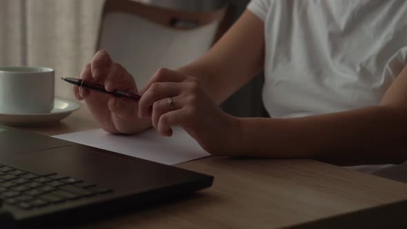 Close Up Hands Of Young Woman Chatting On Laptop At Home In Living Room