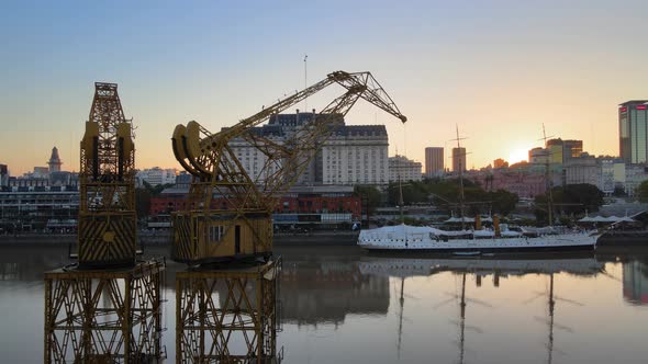 Aerial orbiting view of cranes at Puerto Madero, Buenos Aires, at dusk