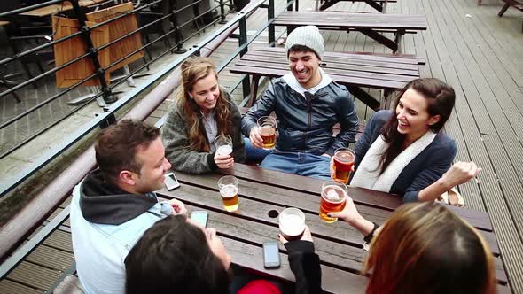 Group of friends enjoying a beer at pub in London