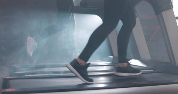 Woman and Man Running on Treadmill at the Gym