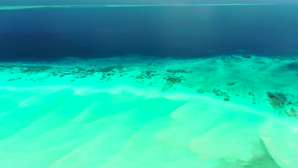 Beautiful overhead abstract shot of a sandy white paradise beach and aqua turquoise water background