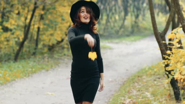 Elegant Woman Walking in a Park