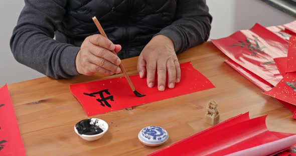 Man Write Chinese Calligraphy for Lunar New Year