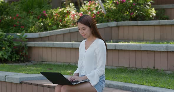 Woman work on laptop computer at outdoor