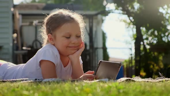 Carefree Girl is Playing on the Tablet