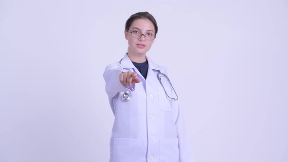 Happy Young Beautiful Woman Doctor Pointing at Camera