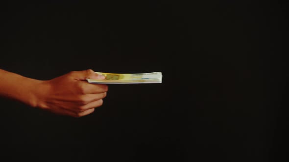 Giving Money on Black Background