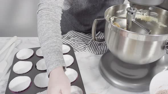 Step by step. Mixing ingredients in a standing kitchen mixer to bake red velvet cupcakes.