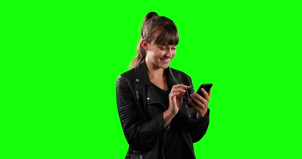 Side view of Caucasian woman using her phone with green screen