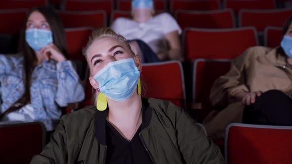 People in masks watch funny movie