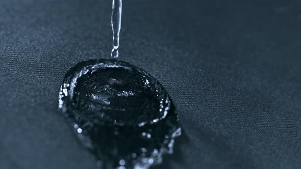 Super Slow Motion Shot of Pouring Water on Waterproof Cloth at 1000Fps.