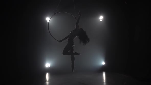 Aerial Acrobat in the Ring. A Young Girl Performs the Acrobatic Elements in the Air Ring. Slow