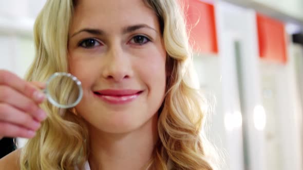 Female customer looking through magnifying glass