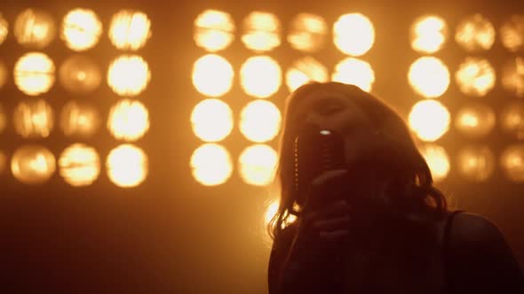 Hot Woman Performer Singing Mic in Night Club Closeup