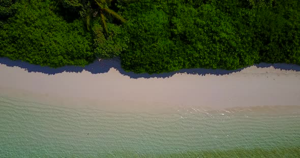 Daytime flying abstract shot of a summer white paradise sand beach and blue sea background in colorf