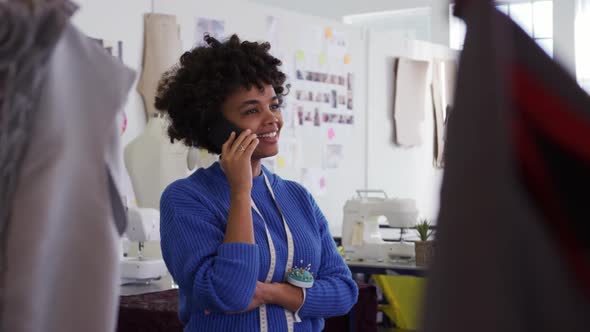 Mixed race woman using smartphone in creative office