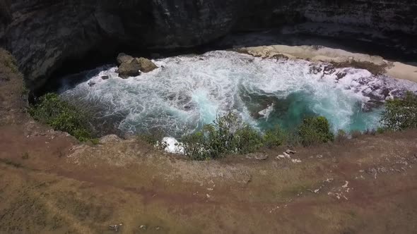 Calmer aerial view flight slowly tilt up drone flight ofBroken Beach at Nusa Penida in Bali Indones