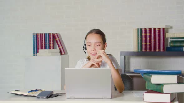 Teenage Girl During an Online Lesson in Front of a Laptop Monitor