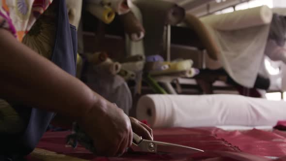 Mixed race woman working at a hat factory