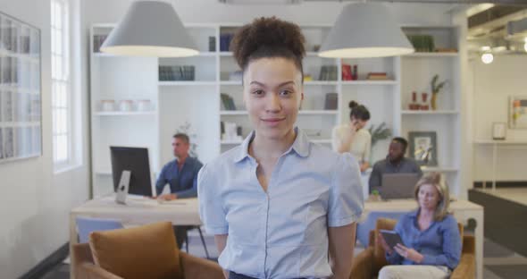 Young woman smiling to camera at the office