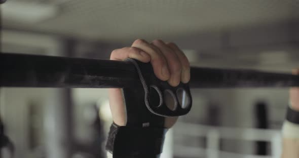 Training Pull Ups, Intense Strength Exercise in Closed Gym. Men Doing Pull Ups Workout