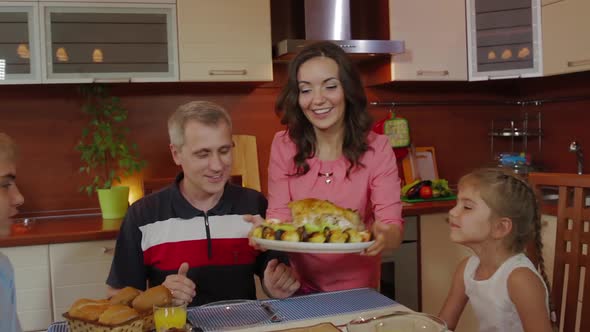 Roasted Chicken Inside Oven Cooking for Christmas Dinner. Woman Takes Cooked Chicken Out of the Oven