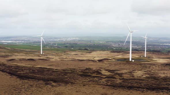 Aerial footage of wind turbines in a field