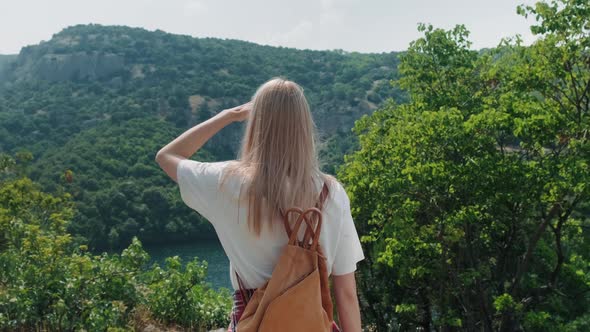 Woman walking towards viewpoint.