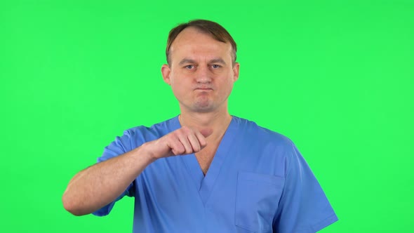 Unhappy Medical Man Showing Thumbs Down Gesture, Green Screen