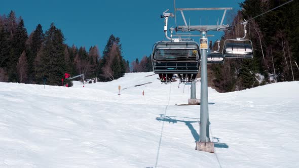 Ski Lift Moving Over Snowy Landscape in Austrian Alps