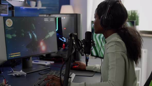 Furious Black Woman Gamer with Headphones Using Stream Chat Losing Game