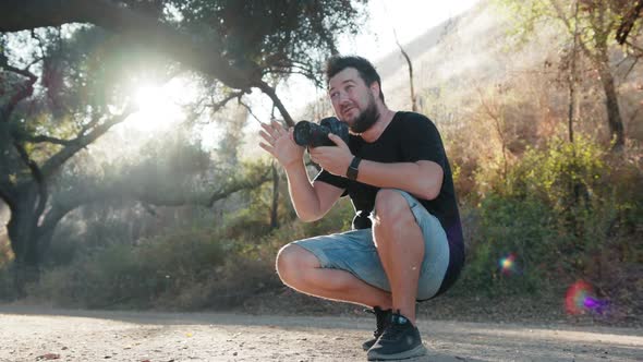 Professional Photographer Directing Models at Outdoor Photoshoot at Backlight