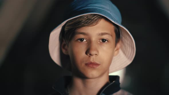 Cinematic Portrait of a Sad Serious Boy Looking at the Camera Indoors Moving Camera Dolly Shot