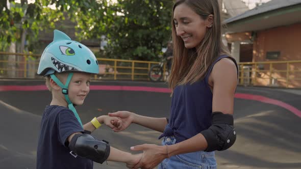 Mom Teaching Son to Stand on Skateboard