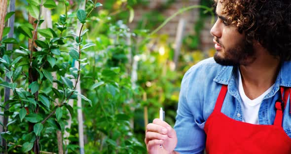 Gardener taking notes of plants