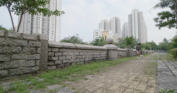 Woman walk with Pomeranian dog