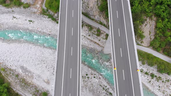 Aerial Top View of Viaduct with Multilane Highway and Tunnel. Traffic on Bridge in Mountains