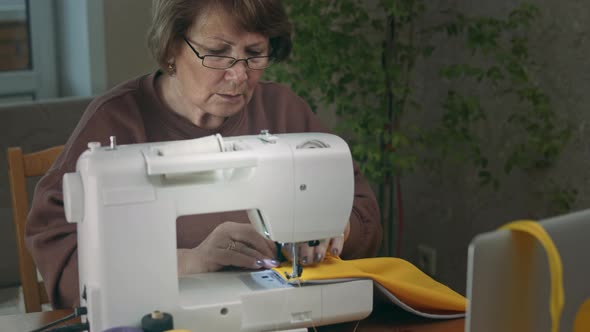 Female Tailor Using Sewing Machine.