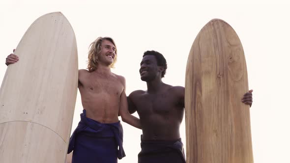 Young multiracial surfers having fun on the beach after surf session - People doing water sport