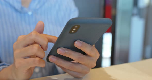 Woman use of mobile phone in restaurant