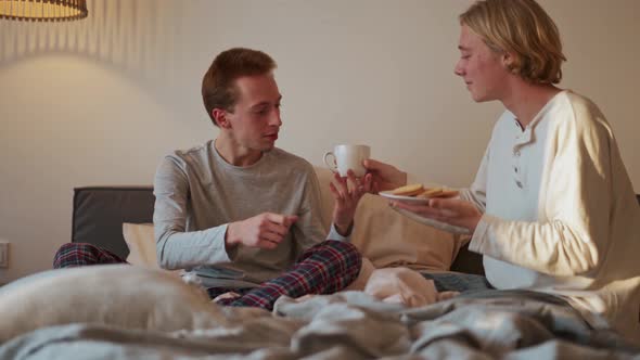 The guy brought breakfast to his boyfriend's bed