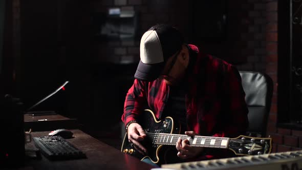 Virtuoso Guitarist Wearing Cap and Glasses Enjoying Performing Favorite Music Playing on Guitar