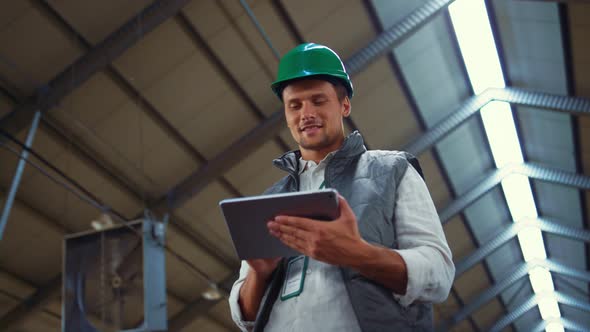 Agribusiness Worker Using Tablet Computer in Shed