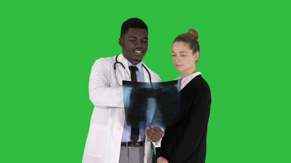 Doctor shows the patient chest x-ray on a Green Screen, Chroma Key.