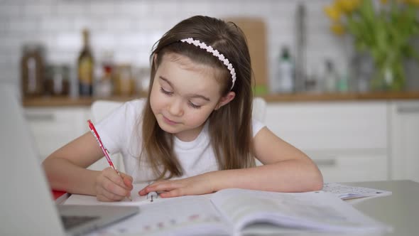 Girl Making Notes During Remote Lesson