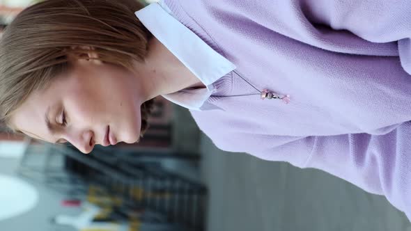 Young Woman Student with Short Fair Hair Waved By Light Wind