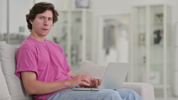 Serious Young Casual Man with Laptop Saying No with Finger