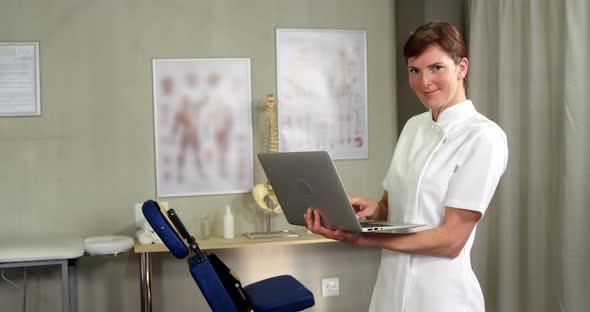 Female physiotherapist using laptop