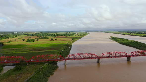 Cars Ride on the Bridge. Wide River on the Island of Luzon, Philippines, Aerial View