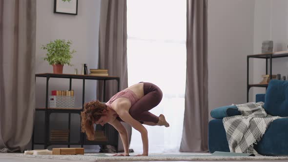 Sporty Strong Woman is Doing Handstand Practicing Yoga in Apartment Performing Asana for Balance and